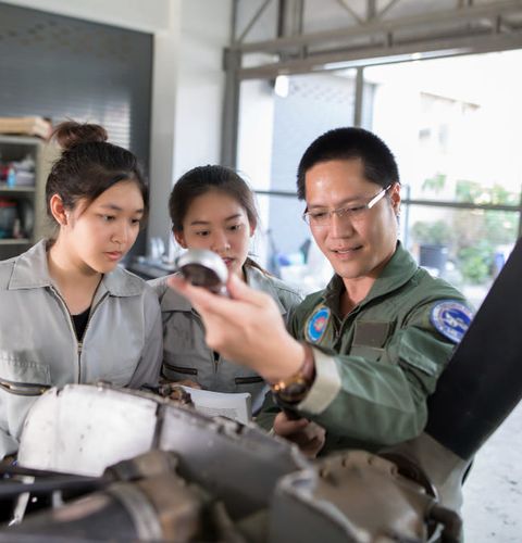 Asian men and women Engineers and technicians are repairing electric and automotive vehicles