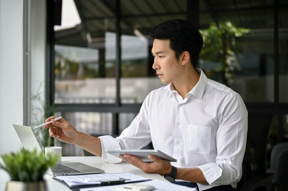 An EOR service consultant from Manpower Vietnam is preparing paperwork for a client 