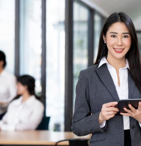 A female consultant holding tablet device for the industry RPO service introduction in Vietnam