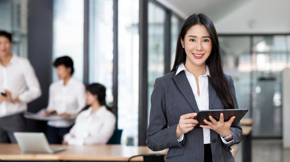 A female consultant holding tablet device for the industry RPO service introduction in Vietnam