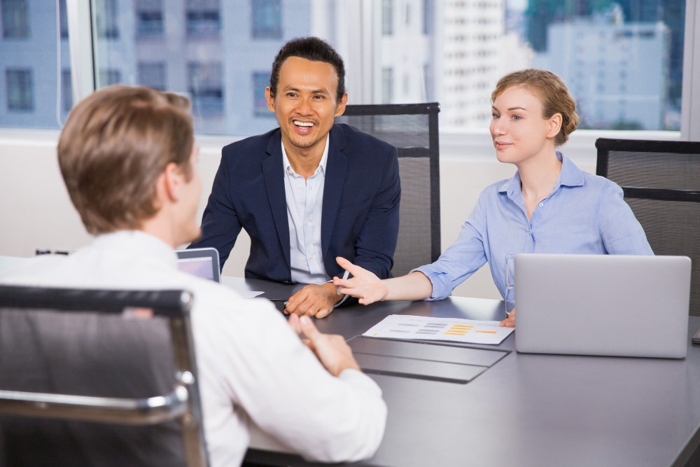 asian western diverse mix business people talking discussion in the meeting room asking questions between interviewer and interviewee