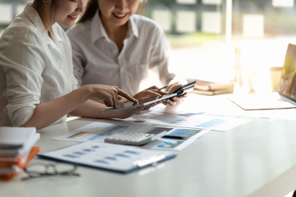 2 workers discussing payroll services in office setting